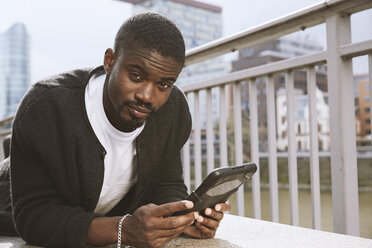 Young man using digital tablet outdoors - STKF001411