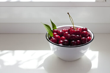 Bowl of sour cherries on window sill - CSF026114