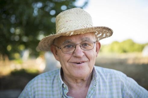 Portrait of smiling farmer with straw hat - RAEF000295