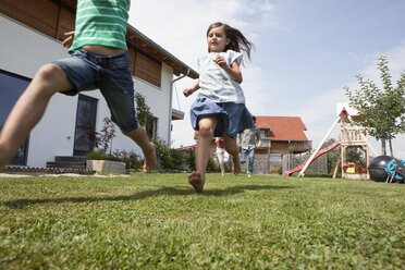 Carefree family running in garden - RBF003475