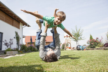 Playful father with son in garden - RBF003480