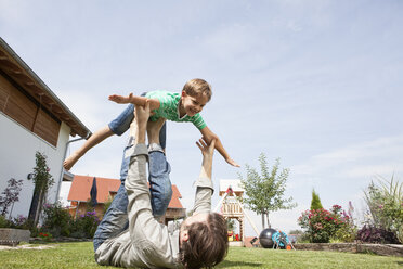 Playful father with son in garden - RBF003481