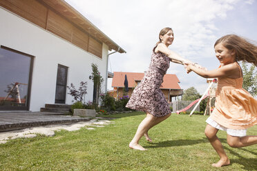 Carefree mother and daughter in garden - RBF003437