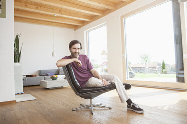 Mature man sitting relaxed in his living room - RBF003342