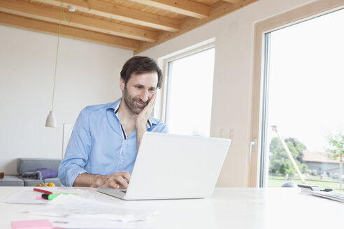 Mature man working from home, using laptop - RBF003270