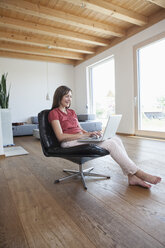 Mature woman using laptop at home - RBF003285