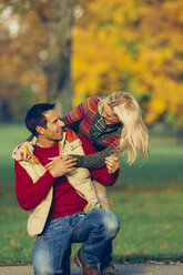 Happy couple in autumnal park - CHAF001159