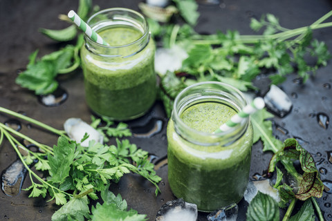 Two glasses of wild herb smoothie with apple, banana and lime juice stock photo