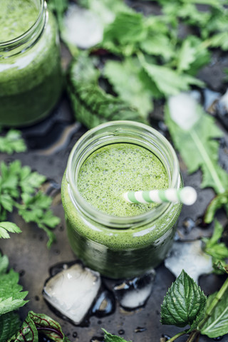 Two glasses of wild herb smoothie with apple, banana and lime juice stock photo