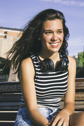 Portrait of smiling teenage girl with headphones - ABZF000100