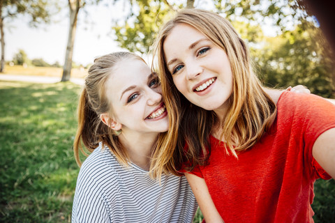 Two happy teenage girls taking a selfie stock photo