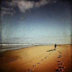 France, Contis-Plage, man walking on the beach looking to the sea - DWI000580