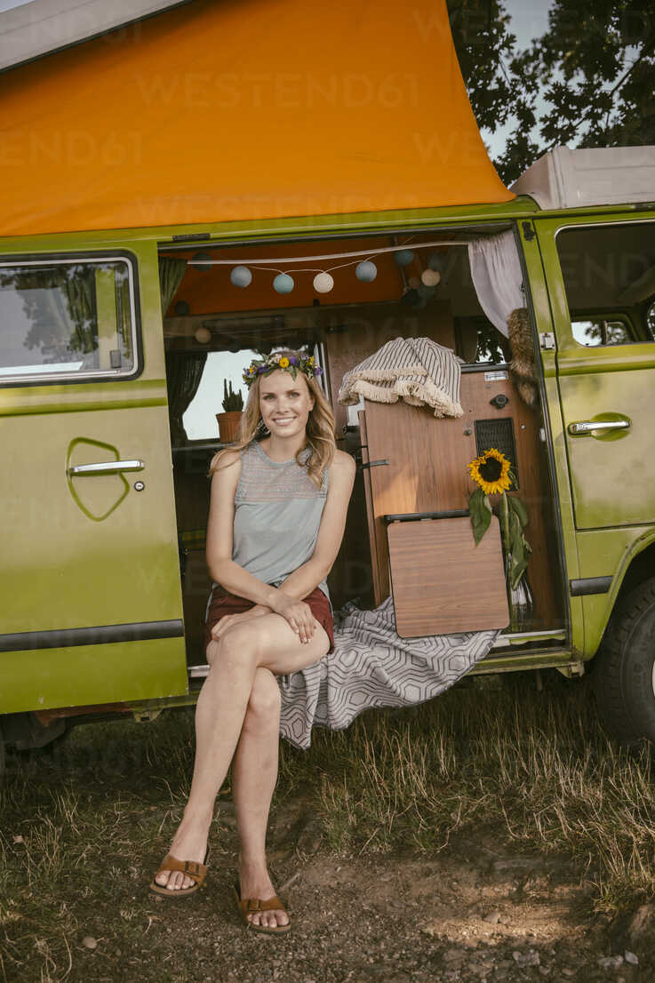 Hippie woman sitting in van in the nature stock photo