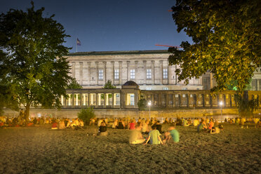 Deutschland, Berlin, Menschen genießen eine laue Sommernacht im James-Simon-Park an der Spree - NKF000347