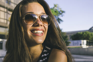 Portrait of smiling teenage girl wearing sunglasses - ABZF000104