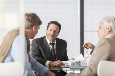 Three businesspeople discussing in office - ZEF007398