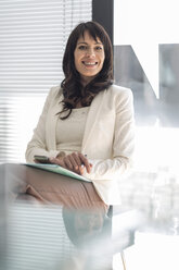 Portrait of smiling businesswoman in office - ZEF007402