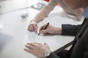 Close-up of man signing a document - ZEF007096