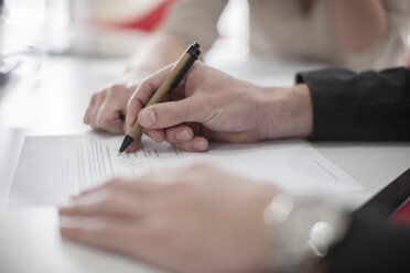 Close-up of man signing a document - ZEF007097