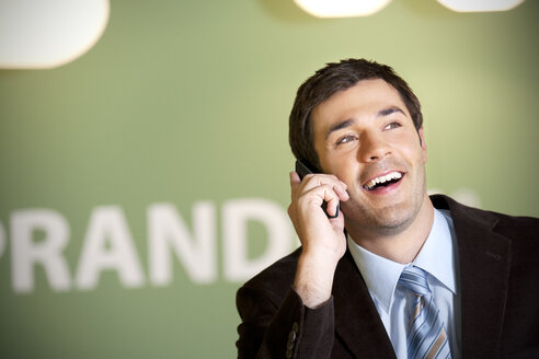Smiling businessman on the phone - TOYF001248