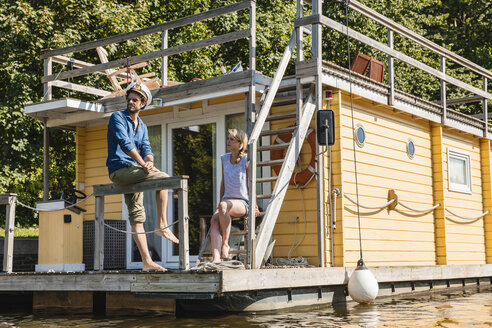 Couple having a trip on a house boat - FMKF001918