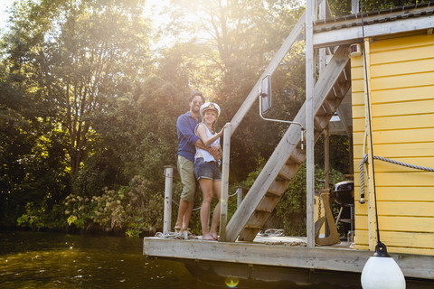 Couple embracing on a house boat stock photo