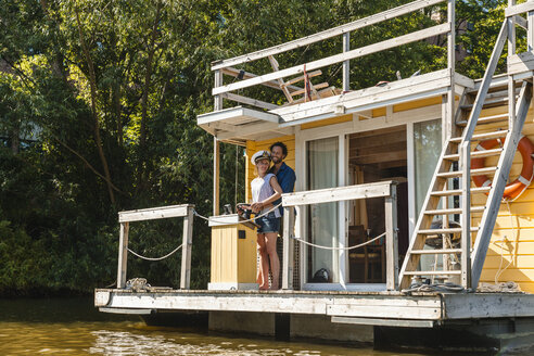 Couple having a trip on a house boat - FMKF001923