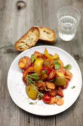 Plate of vegan antipasti, slices of ciabatta and glass of water - KSWF001544