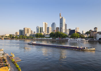 Germany, Hesse, Frankfurt, Financial district, Cargo ship on Main river in the morning - SIEF006731