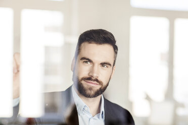 Portrait of businessman behind glass wall - PESF000059