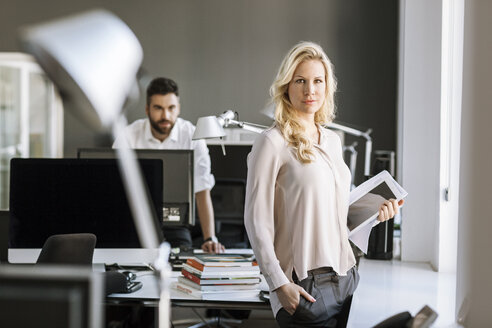 Two colleagues in office with digital tablet and computer - PESF000069