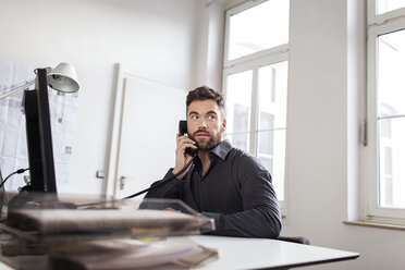 Man at desk in office on the phone - PESF000085