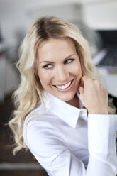 Smiling blond woman in office - PESF000102