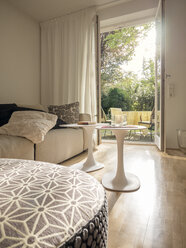 Modern living room with view through open terrace door - LAF001486