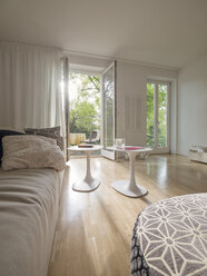 Modern living room with view through open terrace door - LAF001487