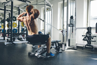 Sportler beim Training mit einer Kabelmaschine - MADF000581