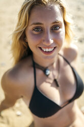 Portrait of smiling young woman on the beach - MGOF000569