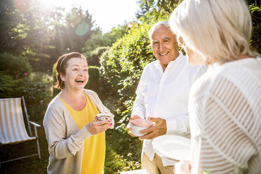 Happy elderly friends in garden - RKNF000220