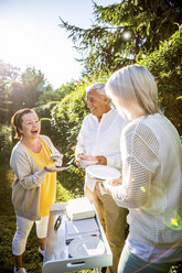 Happy elderly friends in garden - RKNF000221