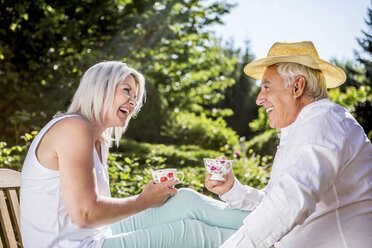 Happy elderly couple in garden - RKNF000361