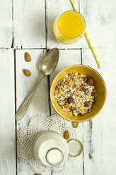 Bowl of fruit muesli, glass of mango smoothie, spoon and bottle of milk - ODF001239