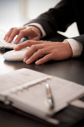 Hands of businessman using mouse and keyboard - TOYF001221