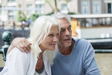 Netherlands, Amsterdam, senior couple embracing outdoors - FMKF002055