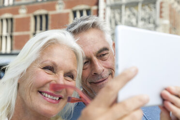 Netherlands, Amsterdam, senior couple taking a selfie - FMKF002052