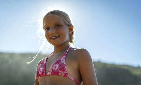 Portrait of a blond little girl wearing bikini top - MGOF000589