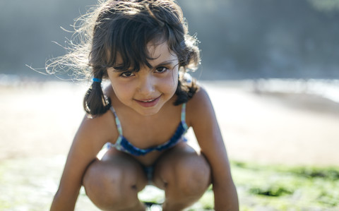 Portrait of smiling little girl on the beach stock photo