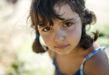 Portrait of serious looking little girl on the beach - MGOF000594