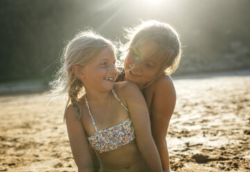 Two sisters having fun together on the beach - MGOF000607