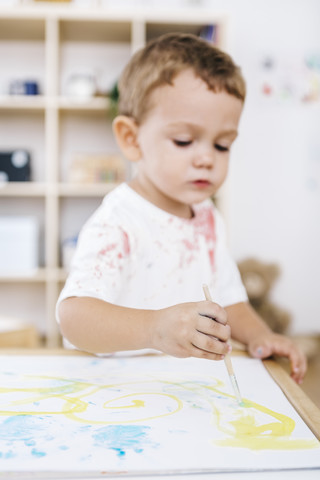Kleiner Junge malt mit Aquarellfarben, lizenzfreies Stockfoto