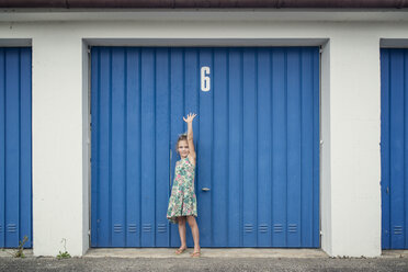 6 year old girl in front of garage door with number 6 - OPF000080